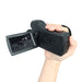 Hand holding black night vision camera with flip-out screen showing cows in dark field TUTT