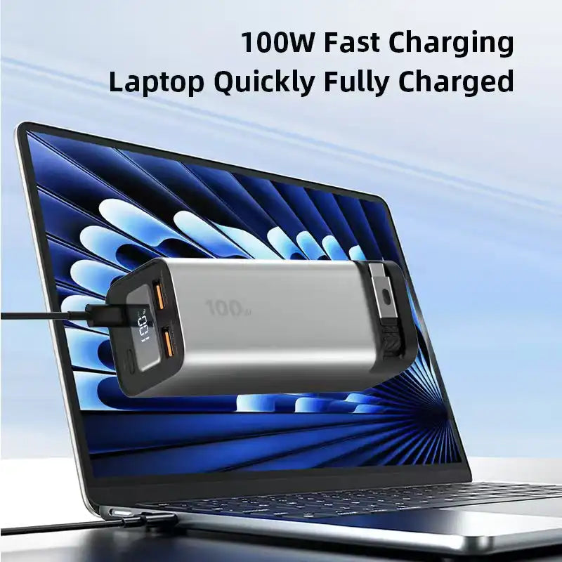 Silver 100W 20000mAh fast charging power bank connected to laptop showing digital screen charging status TUTT