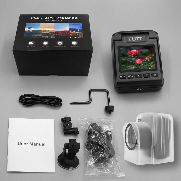 TUTT 4K time-lapse camera kit with accessories, user manual, and retail box on gray surface TUTT