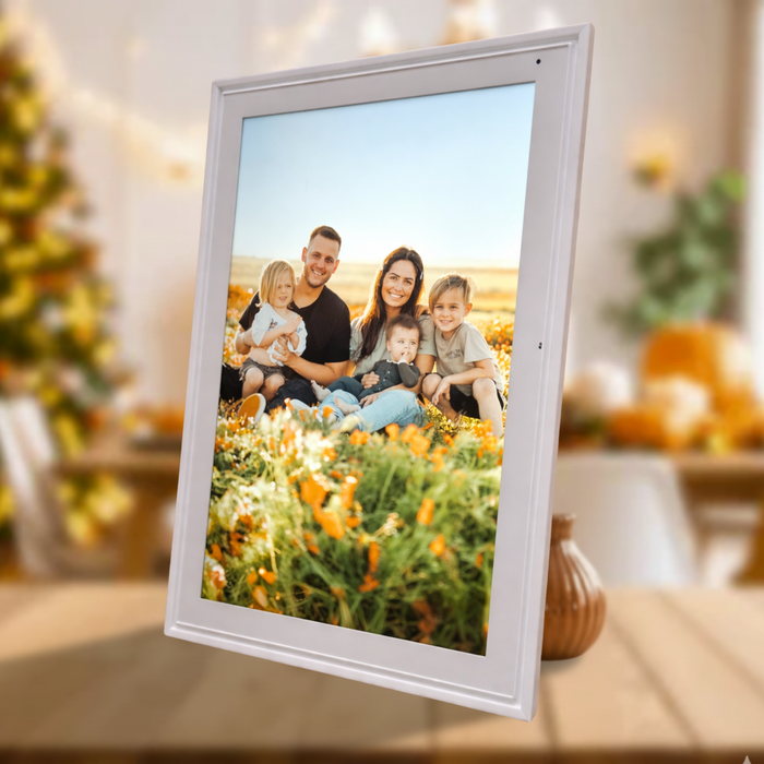 Digital photo frame displaying a smiling family of five in a vibrant outdoor flower field, modern white frame TUTT