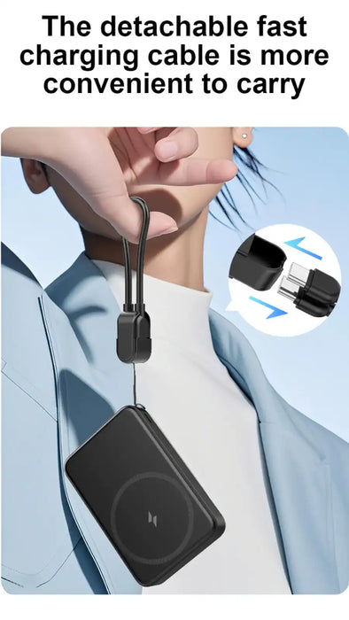 Hand holding a black portable power bank with a detachable fast charging cable against a person wearing a blue jacket and white top TUTT