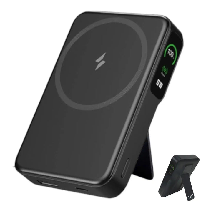 Black wireless power bank with digital display showing 100% charge on side, adjustable stand TUTT