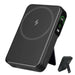 Black wireless power bank with digital display showing 100% charge on side, adjustable stand TUTT