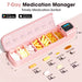 Pink 7-day medication manager pill organizer with digital display and compartments labeled by day, holding various pills and capsules TUTT