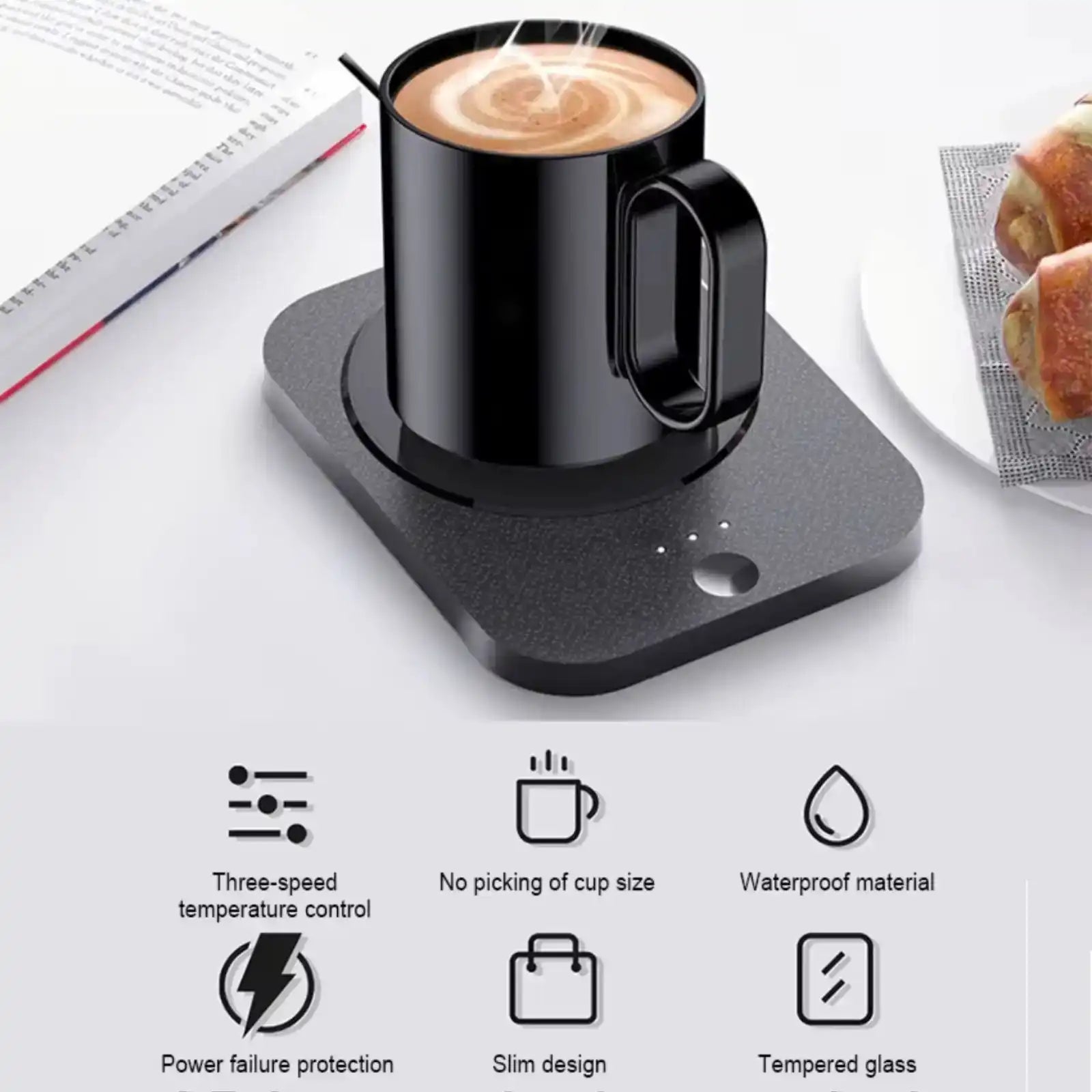 USB coffee warmer with black mug on desk, pastries and book nearby, feature icons shown. TUTT